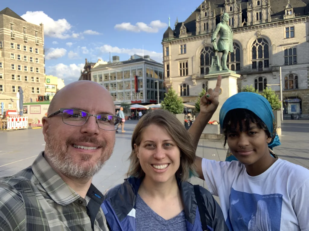 Me, Kat, and Elly standing at the statue of Handel in Halle.